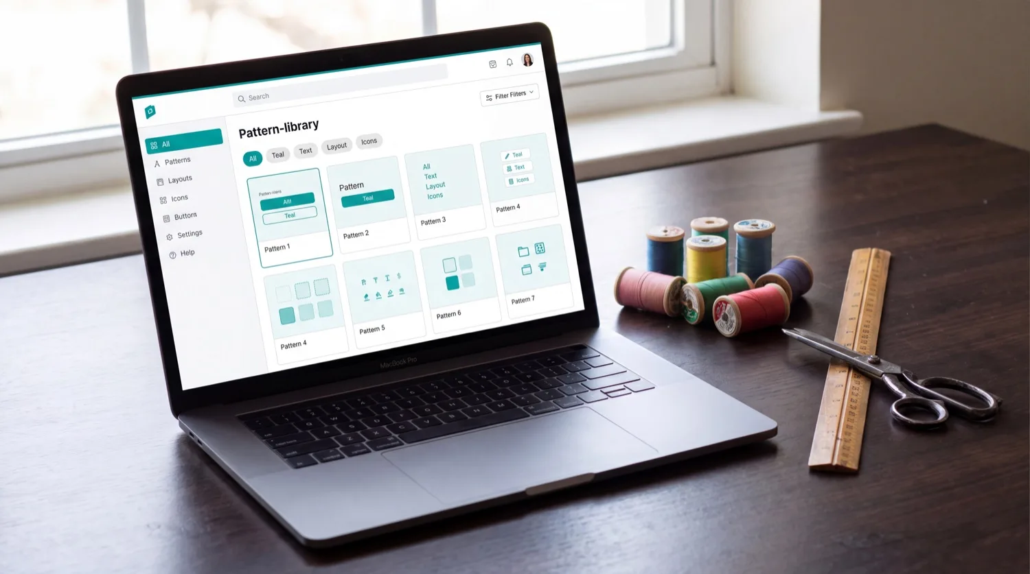 THE NUMBER & NEEDLE CO — the PRIMESTITCH™ app open on a laptop, showing the design library with filters